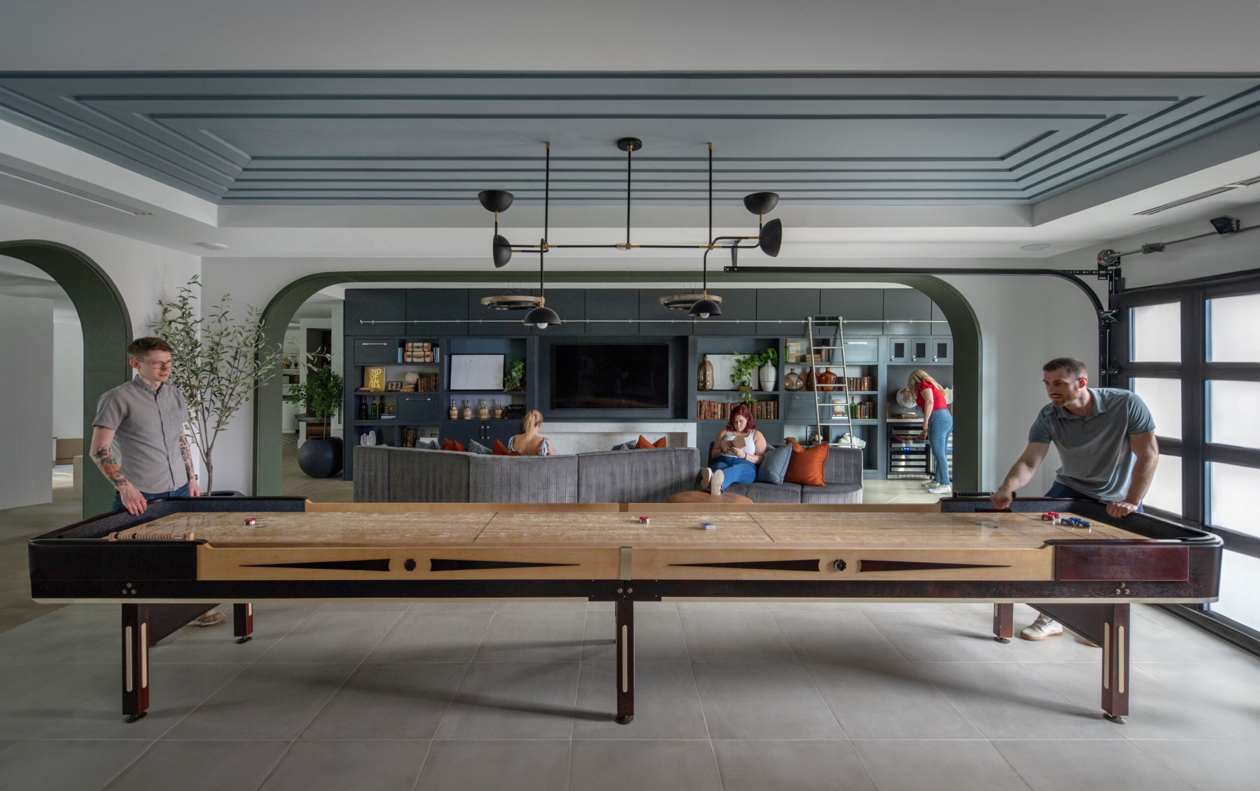 Game room with shuffleboard featured and lounge area in the background